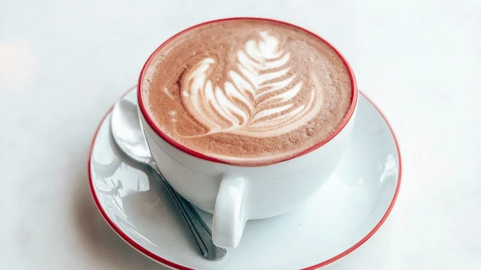 white ceramic cup with saucer on white table