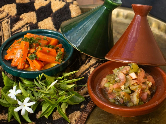 a plate with a bowl of food and a bowl of vegetables