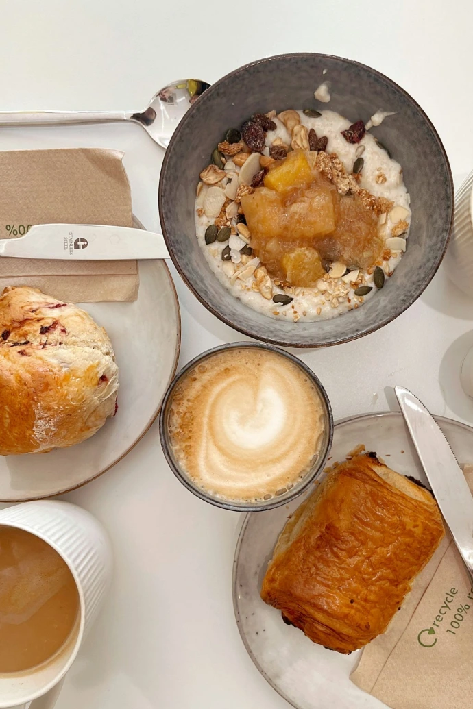 bread on white ceramic plate beside bread on white table